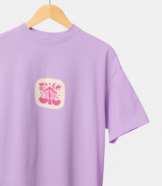 Purple t-shirt with a yellow emblem on a hanger against a white background