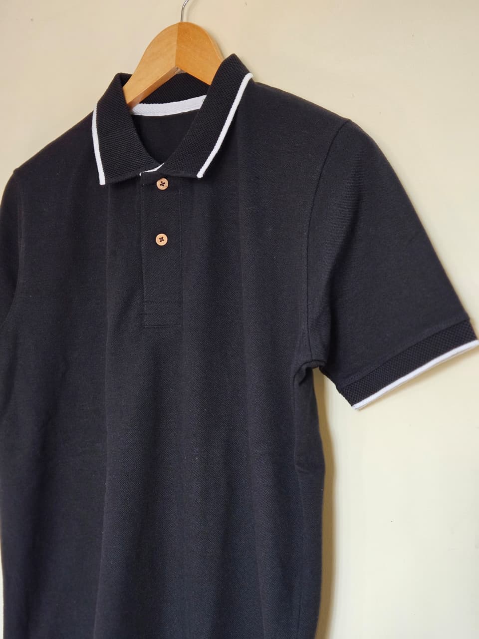 black polo t shirt white tipping India
cotton polo t shirt black classic fit
minimal polo t shirt smart casual style
black polo with contrast collar design
premium cotton polo t shirt men women
