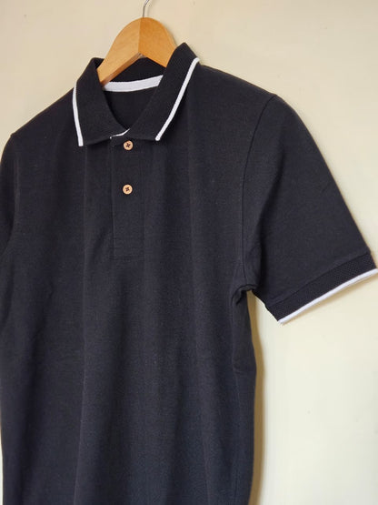 black polo t shirt white tipping India
cotton polo t shirt black classic fit
minimal polo t shirt smart casual style
black polo with contrast collar design
premium cotton polo t shirt men women
