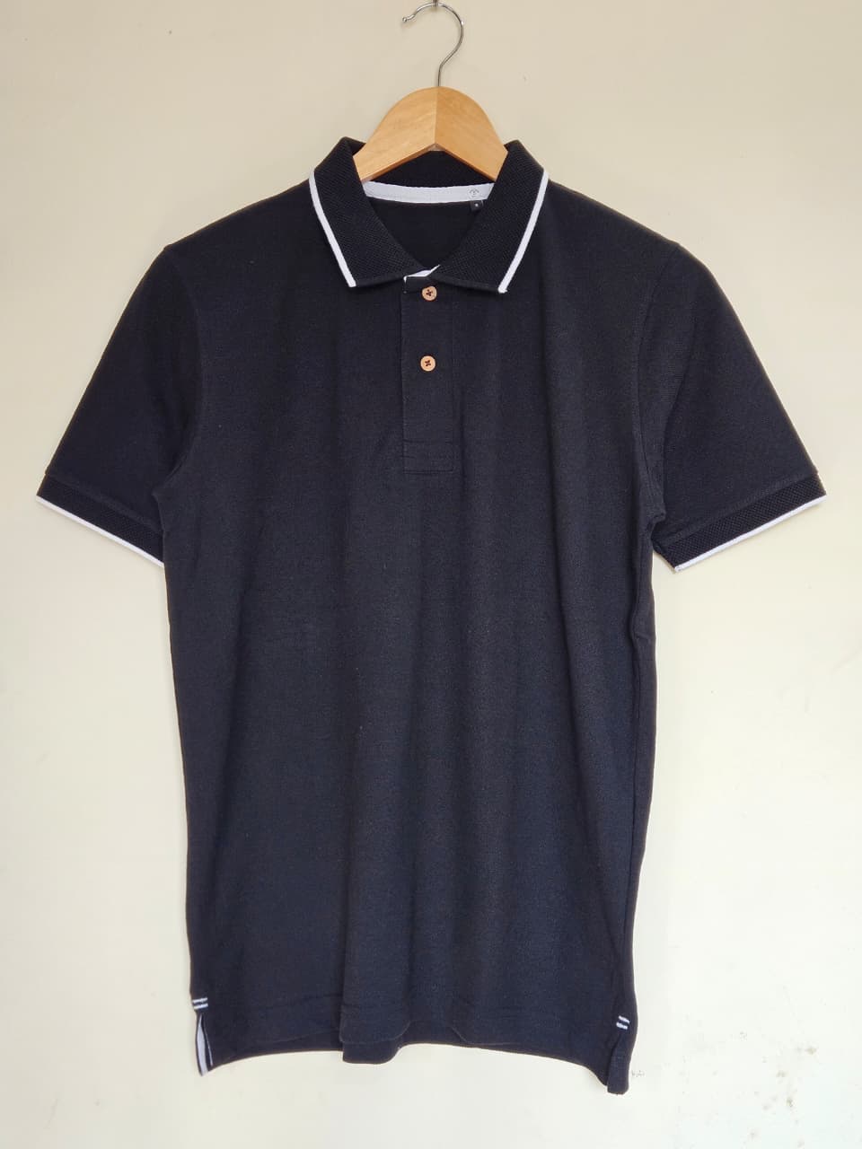 black polo t shirt white tipping India
cotton polo t shirt black classic fit
minimal polo t shirt smart casual style
black polo with contrast collar design
premium cotton polo t shirt men women