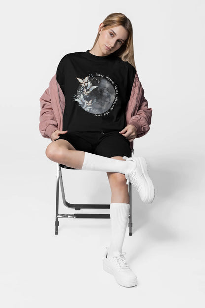 Black oversized celestial moon t-shirt styled for streetwear look