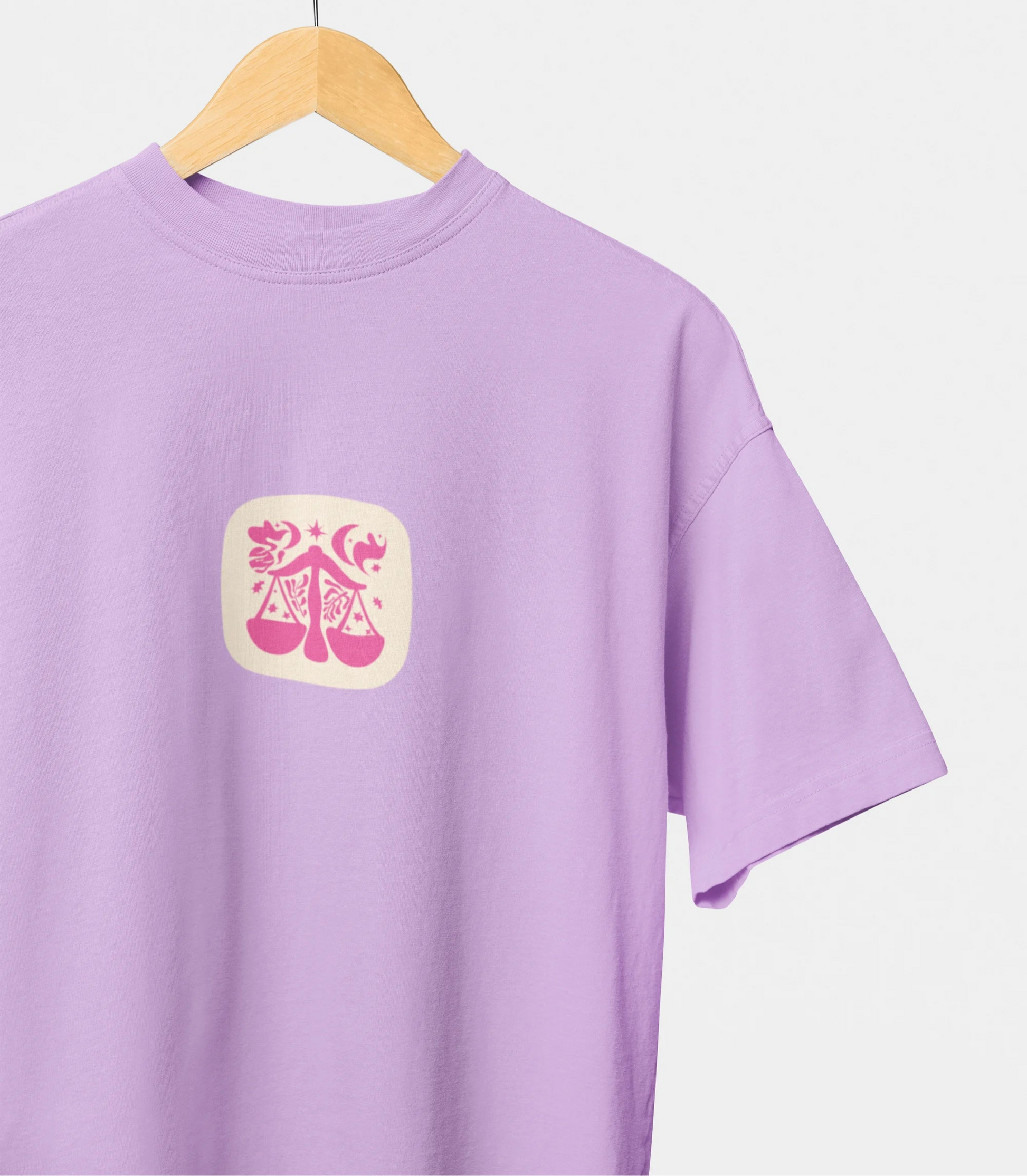 Purple t-shirt with a yellow emblem on a hanger against a white background